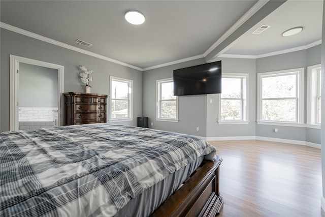 bedroom with crown molding and light wood-type flooring