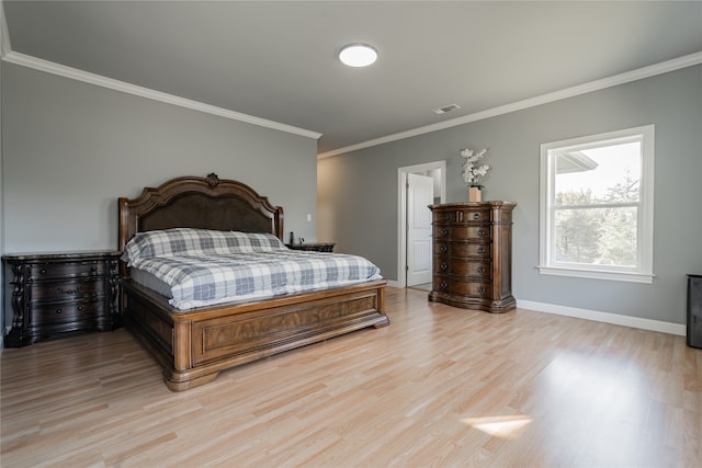 bedroom featuring crown molding and light wood-type flooring