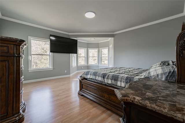 bedroom with crown molding and light hardwood / wood-style floors