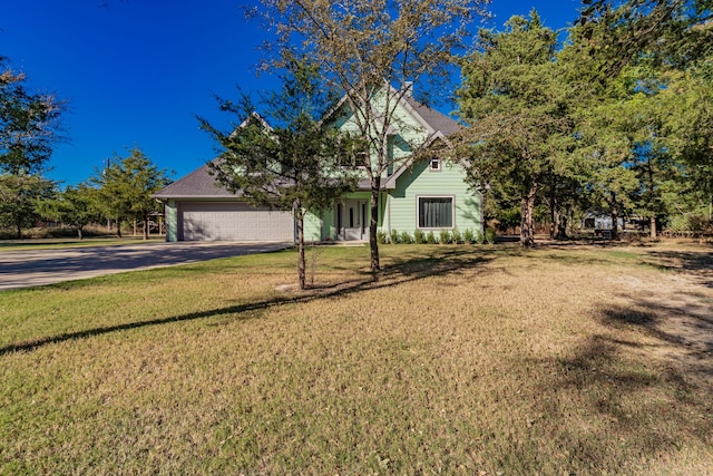 obstructed view of property featuring a front lawn and a garage