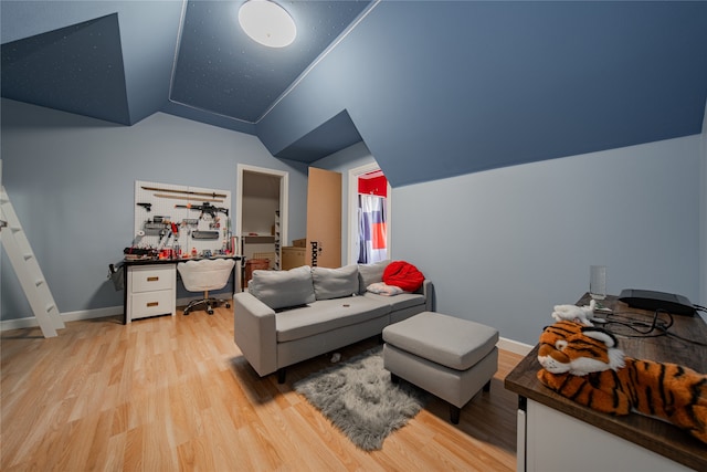 living room with vaulted ceiling and light wood-type flooring