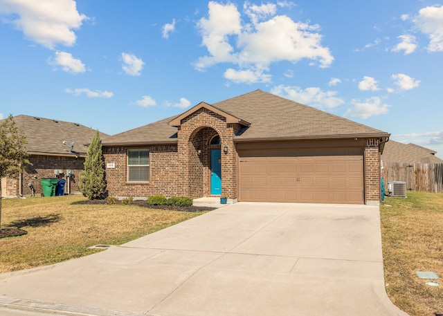 ranch-style house featuring a front yard, central AC, and a garage