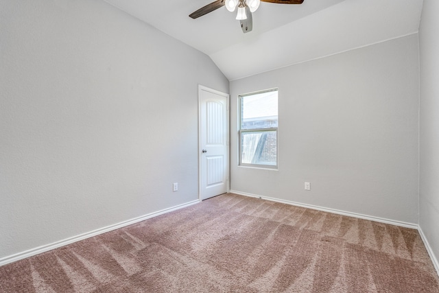 unfurnished room featuring ceiling fan, lofted ceiling, and carpet floors