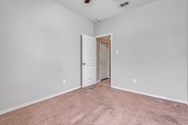 carpeted spare room with ceiling fan