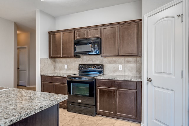 kitchen with dark brown cabinetry, black appliances, tasteful backsplash, and light tile patterned floors