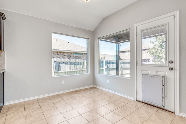 tiled foyer entrance with plenty of natural light and vaulted ceiling