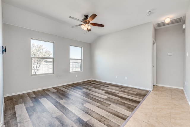 empty room featuring lofted ceiling, hardwood / wood-style floors, and ceiling fan