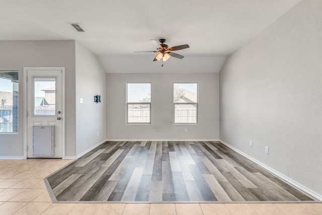 empty room featuring light hardwood / wood-style floors, ceiling fan, and vaulted ceiling