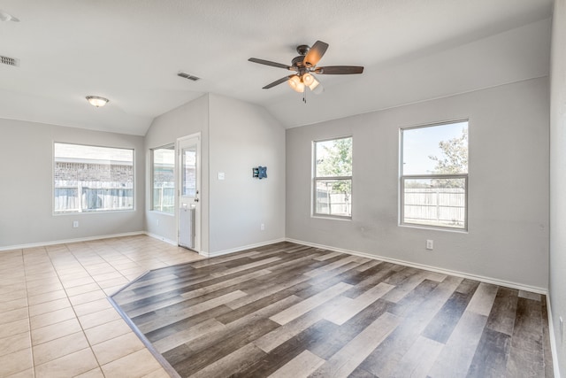 empty room featuring lofted ceiling, wood-type flooring, and ceiling fan