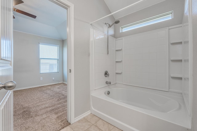 bathroom featuring lofted ceiling, tile patterned floors, washtub / shower combination, and ceiling fan