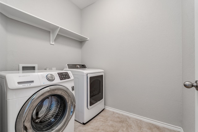 clothes washing area featuring washing machine and clothes dryer