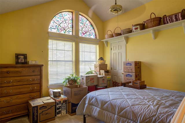 bedroom with ceiling fan, carpet, and lofted ceiling