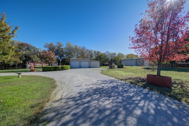 exterior space featuring an outbuilding, a garage, and a front lawn