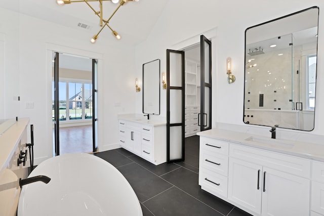 bathroom with tile patterned floors, plus walk in shower, vaulted ceiling, a notable chandelier, and vanity