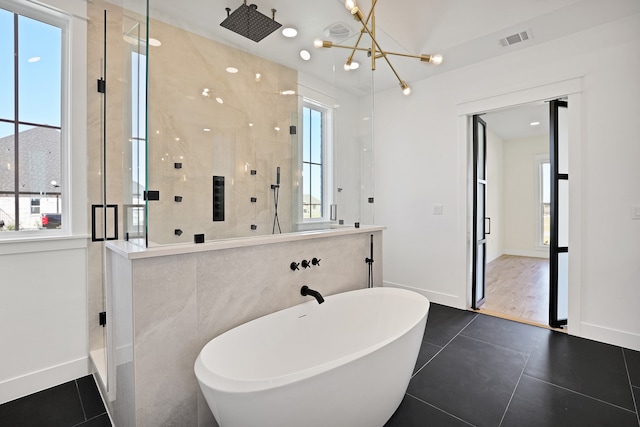 bathroom with tile patterned floors, independent shower and bath, and a chandelier