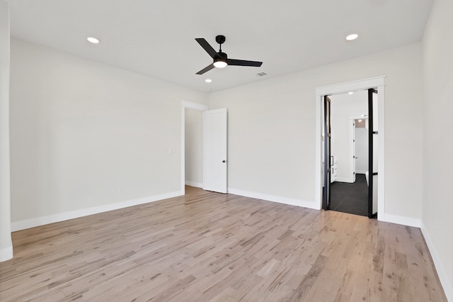 spare room featuring light wood-type flooring and ceiling fan