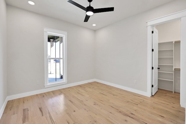 spare room featuring light hardwood / wood-style flooring and ceiling fan