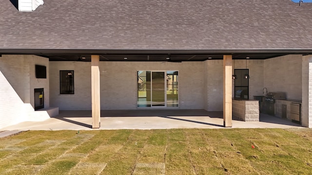 back of property with a patio and a lawn