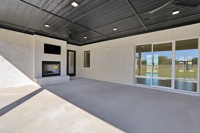 view of patio with an outdoor brick fireplace