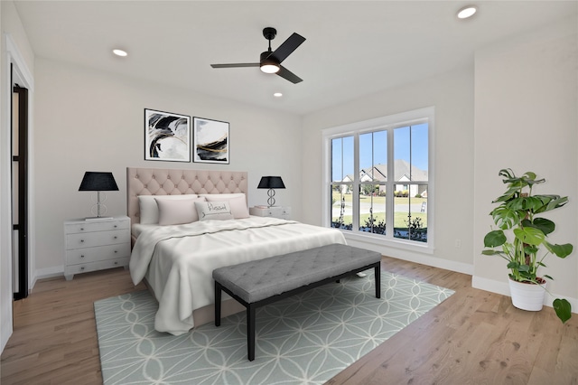 bedroom featuring light wood-type flooring and ceiling fan