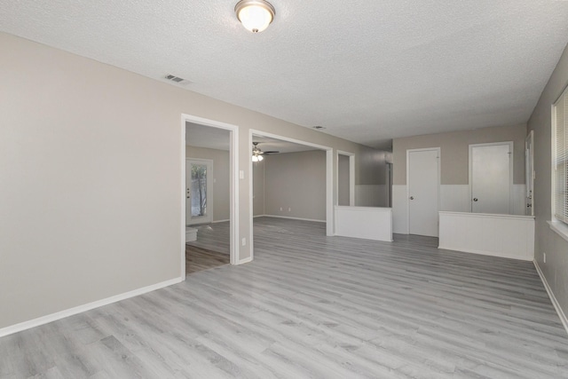 509 Ridgeview Dr, Rockwall, TX 75087 - spare room featuring a textured ceiling, light wood finished floors, ceiling fan, and baseboards