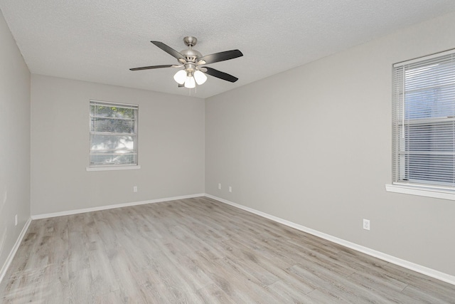 509 Ridgeview Dr, Rockwall, TX 75087 - spare room with light wood-style floors, a textured ceiling, ceiling fan, and baseboards
