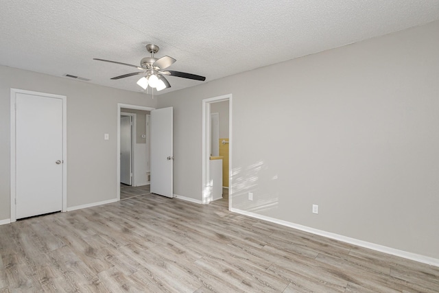 509 Ridgeview Dr, Rockwall, TX 75087 - unfurnished bedroom featuring light wood-style flooring, a textured ceiling, baseboards, and ceiling fan