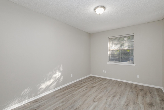 509 Ridgeview Dr, Rockwall, TX 75087 - empty room featuring light wood-type flooring, a textured ceiling, and baseboards