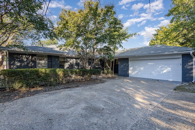 ranch-style home featuring a garage