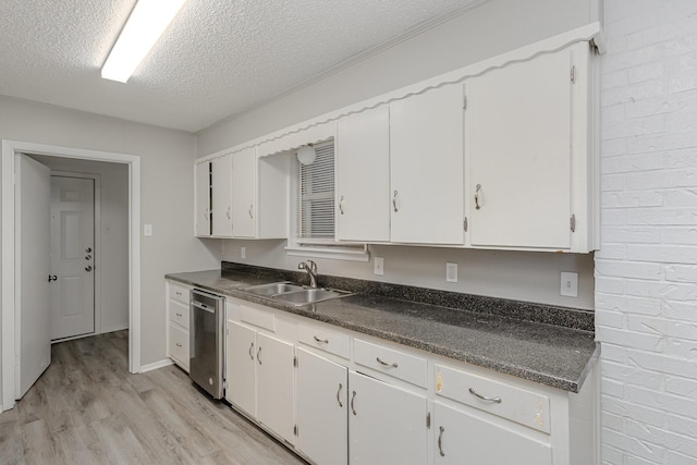 509 Ridgeview Dr, Rockwall, TX 75087 - kitchen with a sink, dishwasher, a textured ceiling, light wood-style flooring, and dark countertops