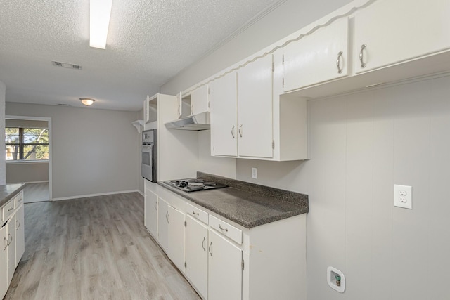 509 Ridgeview Dr, Rockwall, TX 75087 - kitchen featuring electric cooktop, oven, a textured ceiling, dark countertops, and light wood-style floors