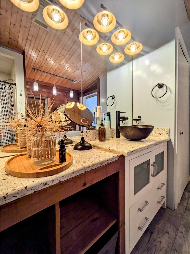 bathroom featuring a shower with curtain, vanity, and wood ceiling