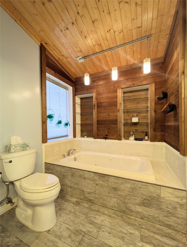 bathroom with track lighting, toilet, a bathtub, and wooden ceiling