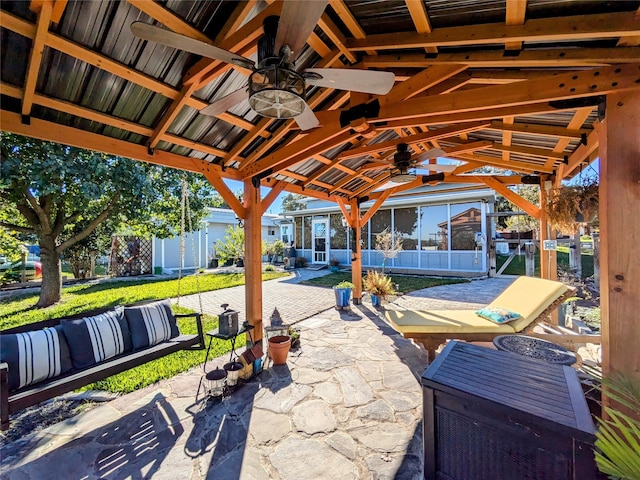 view of patio with a gazebo, a sunroom, and ceiling fan