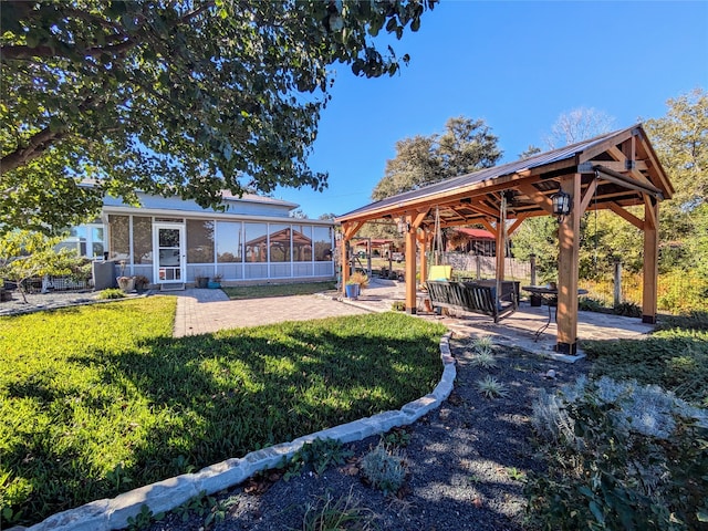 view of yard with a gazebo and a sunroom