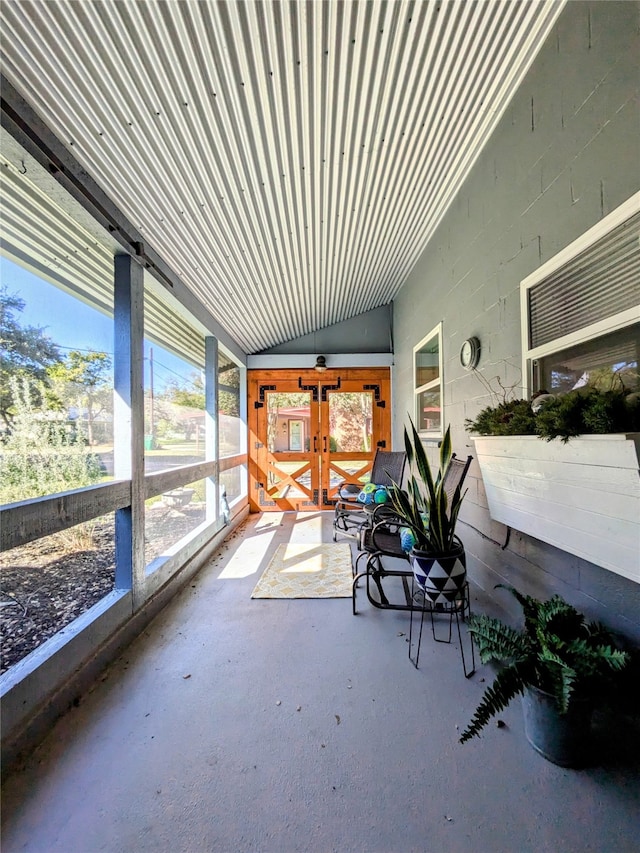 unfurnished sunroom featuring lofted ceiling