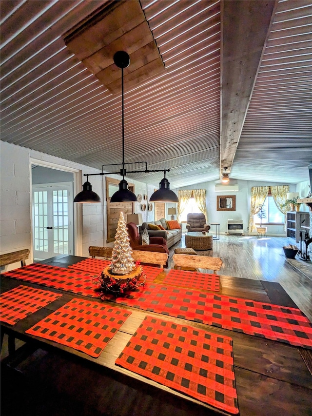 unfurnished dining area featuring wood-type flooring, french doors, and a wealth of natural light