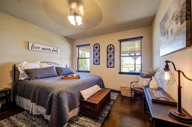 bedroom featuring multiple windows and ceiling fan