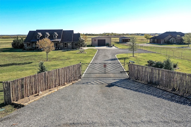 view of front of home with a garage, an outbuilding, and a front lawn