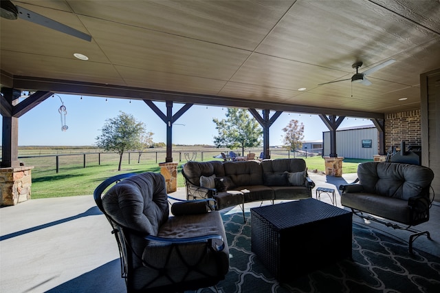 view of patio / terrace featuring outdoor lounge area, ceiling fan, and a rural view