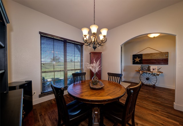 dining space with dark hardwood / wood-style flooring and a notable chandelier