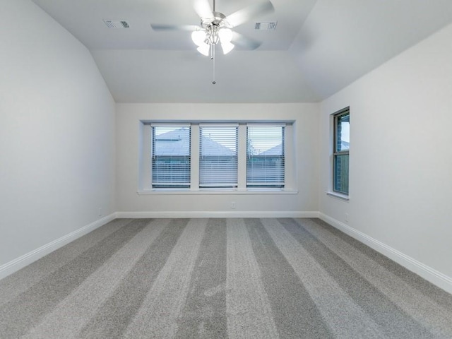 spare room featuring ceiling fan, lofted ceiling, and carpet floors