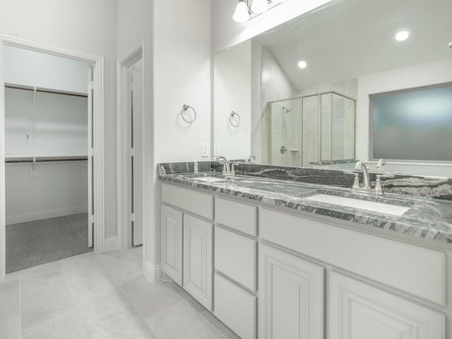 bathroom featuring vanity, tile patterned floors, and walk in shower