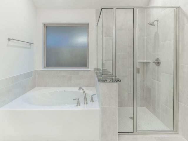 bathroom with shower with separate bathtub