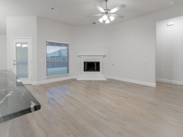 unfurnished living room featuring light hardwood / wood-style floors and ceiling fan