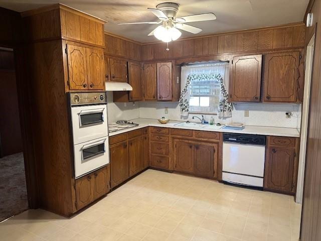 6371 Buncombe Rd, Shreveport, LA 71129 - kitchen featuring white appliances, under cabinet range hood, light countertops, a sink, and a ceiling fan