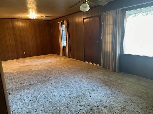 6371 Buncombe Rd, Shreveport, LA 71129 - interior space featuring wooden walls, plenty of natural light, and carpet floors
