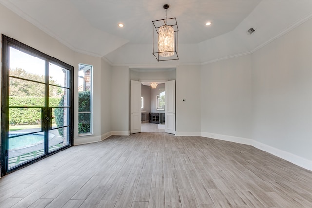 unfurnished room with ornamental molding, a chandelier, and light wood-type flooring