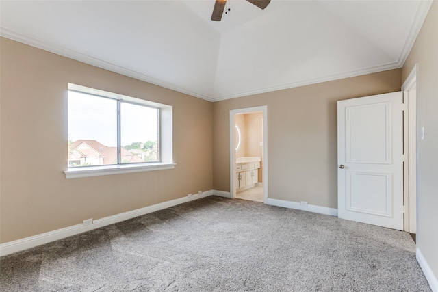 unfurnished bedroom featuring lofted ceiling, ceiling fan, carpet flooring, ornamental molding, and ensuite bath