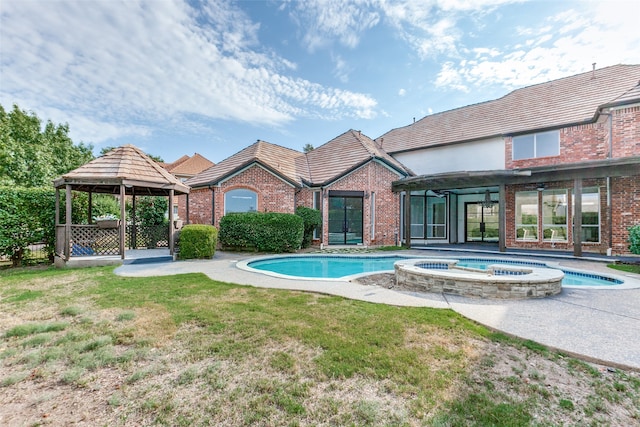 view of swimming pool with an in ground hot tub, a gazebo, a patio area, and a yard